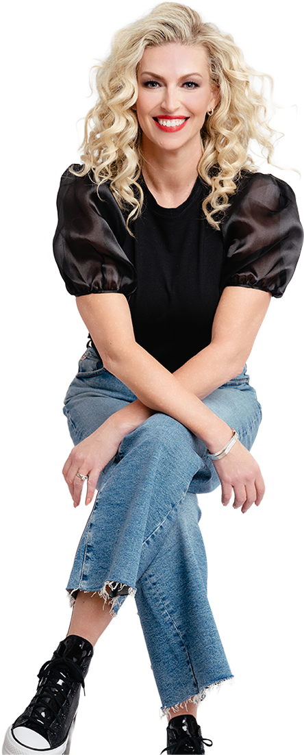 Sara Ross speaker in a black shirt with puffy sleeves and blue jeans sitting down and smiling at the camera