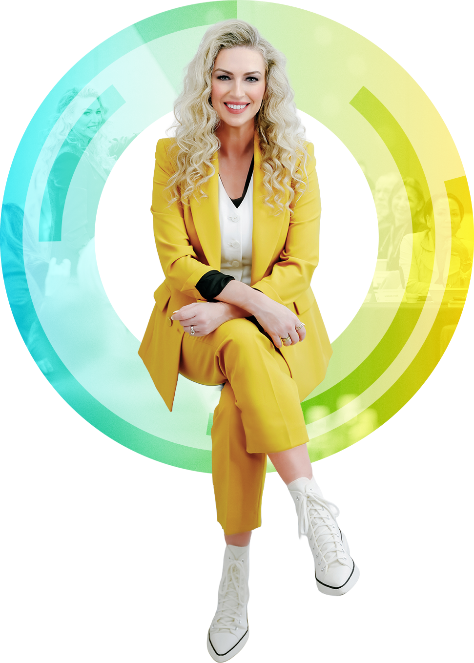 Sara Ross in a yellow blazer and pants sitting on a multicolored circle smiling at the camera